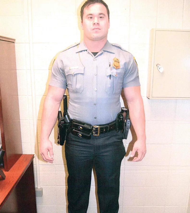 Daniel Holtzclaw in uniform, standing against a cinder-block wall, June 18, 2014.