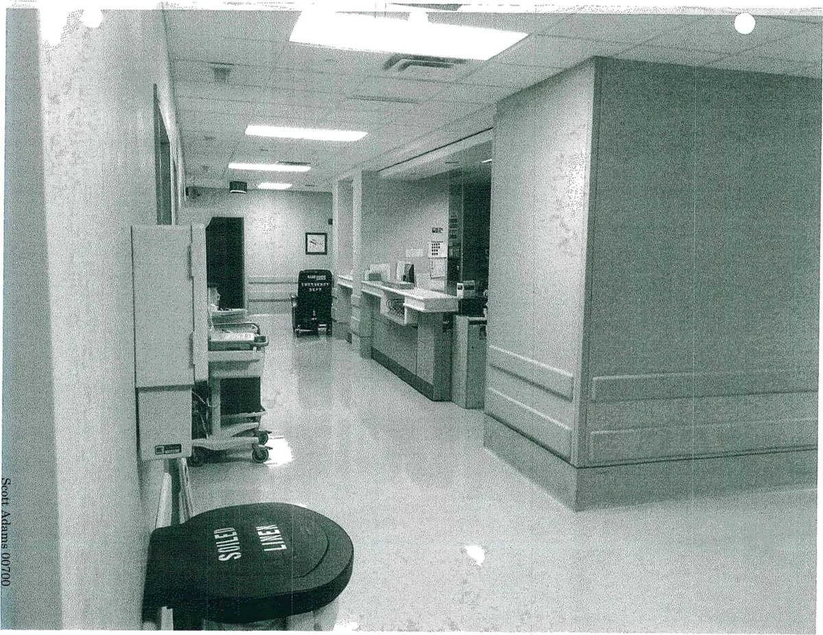 Hospital hallway with a nurses' station counter on the right